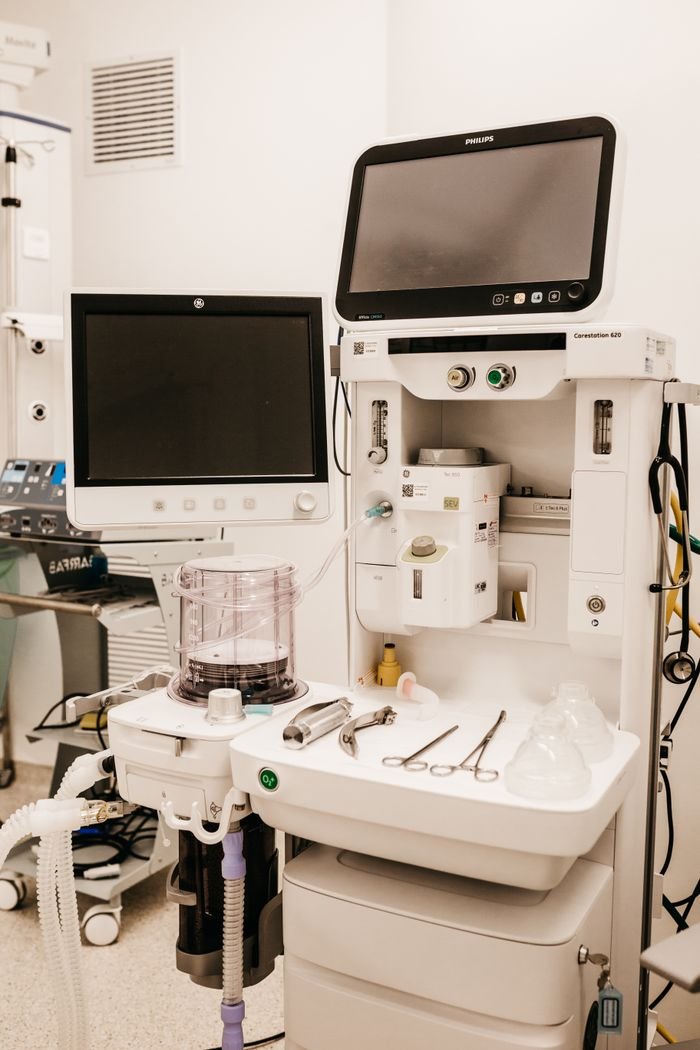 services-img High-tech medical equipment setup in a hospital room, featuring monitors and surgical tools.